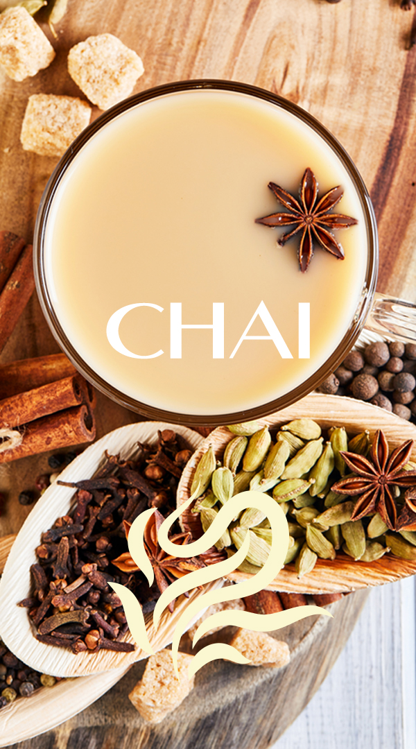 Traditional Indian drink - masala tea with spices. Cinnamon, cardamom, anise, sugar, cloves, pepper on a light wooden background.